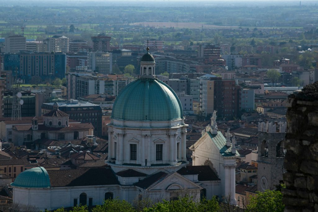 A picturesque aerial view of the iconic Brescia Cathedral dome amidst the cityscape of Brescia, Italy.