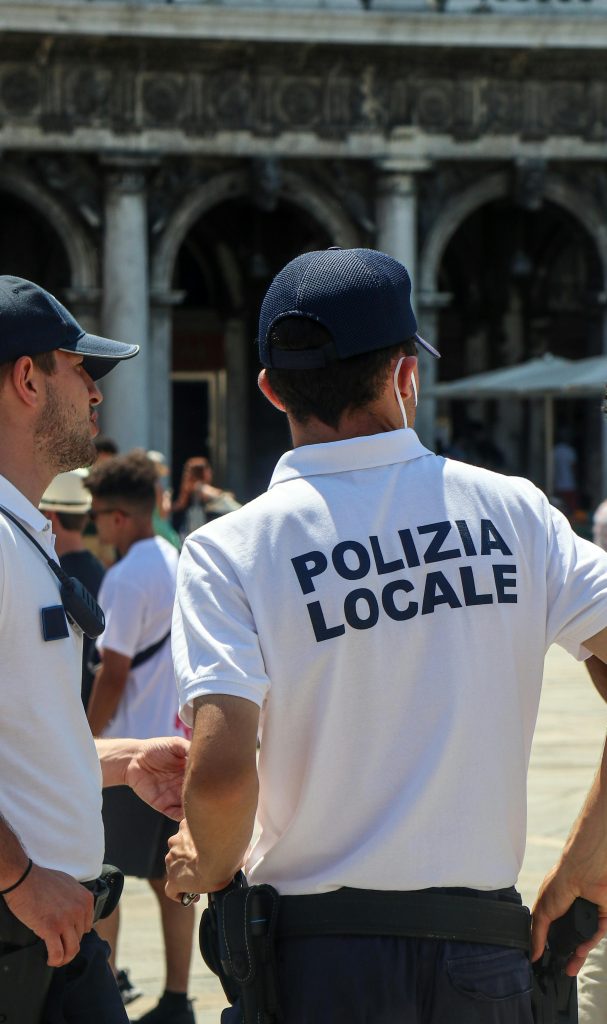 Local police officers patrolling a historic city square, ensuring public safety and order.
