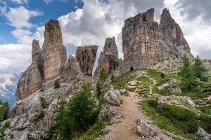 Stunning view of the Cinque Torri rock formations in the Dolomites, Italy, under a cloudy sky.