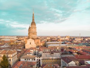 A breathtaking aerial view of Novara, Italy, showcasing the iconic Basilica of San Gaudenzio against a vibrant cityscape.