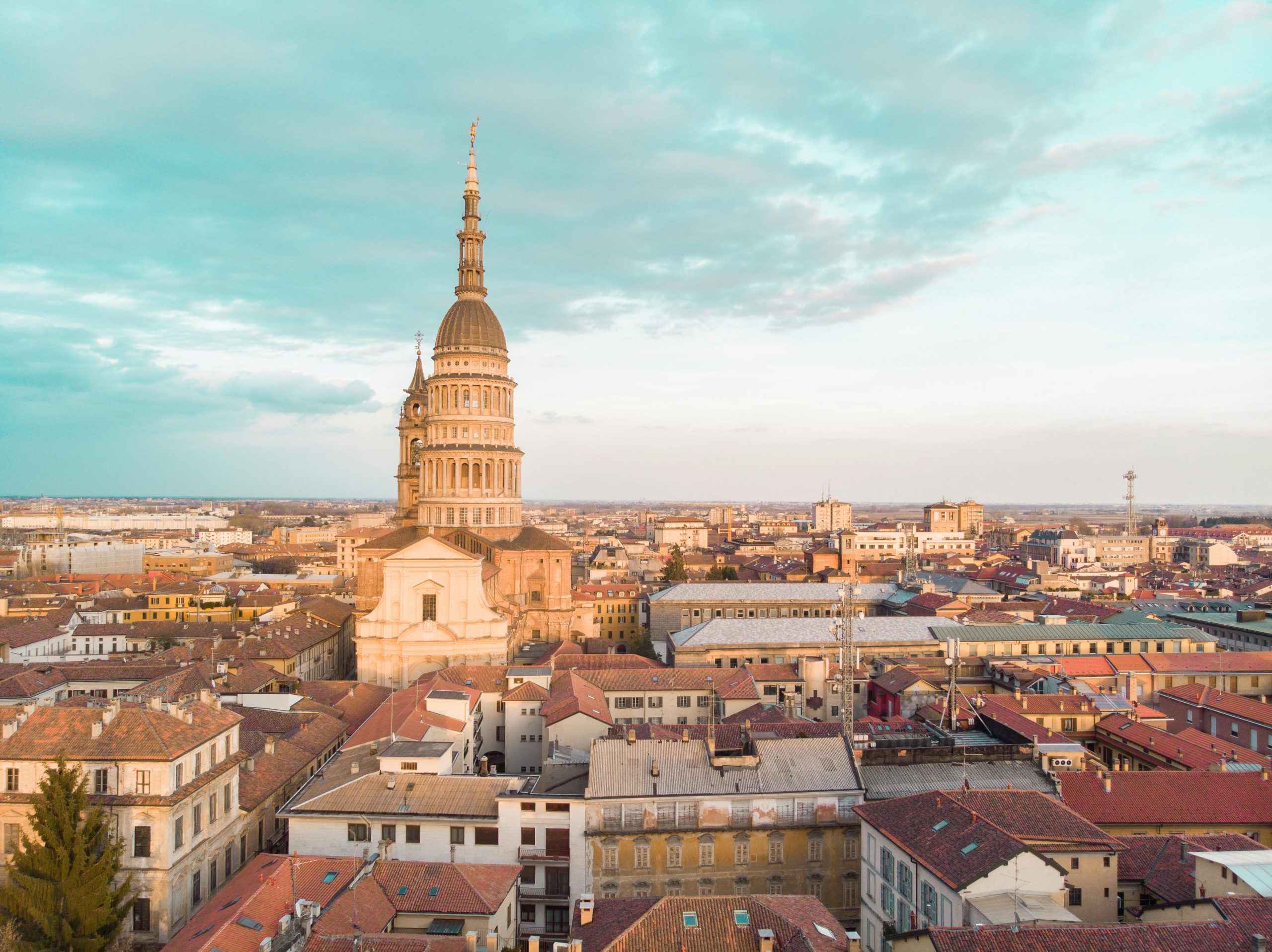A breathtaking aerial view of Novara, Italy, showcasing the iconic Basilica of San Gaudenzio against a vibrant cityscape.
